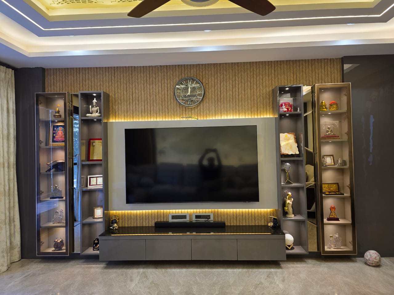 Living room feature wall — backlit TV unit with wooden panelling — DesigningAxis by Shivani