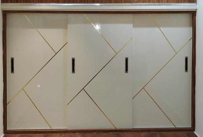 Pink arched wardrobe with floral wallpaper in bedroom, Noida