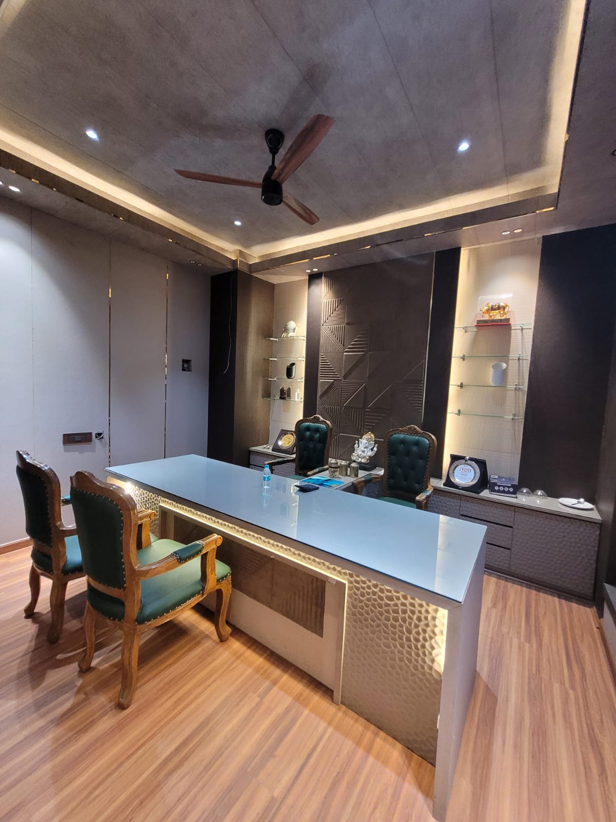 Luxury commercial office with green leather chairs and backlit feature wall, Ghaziabad