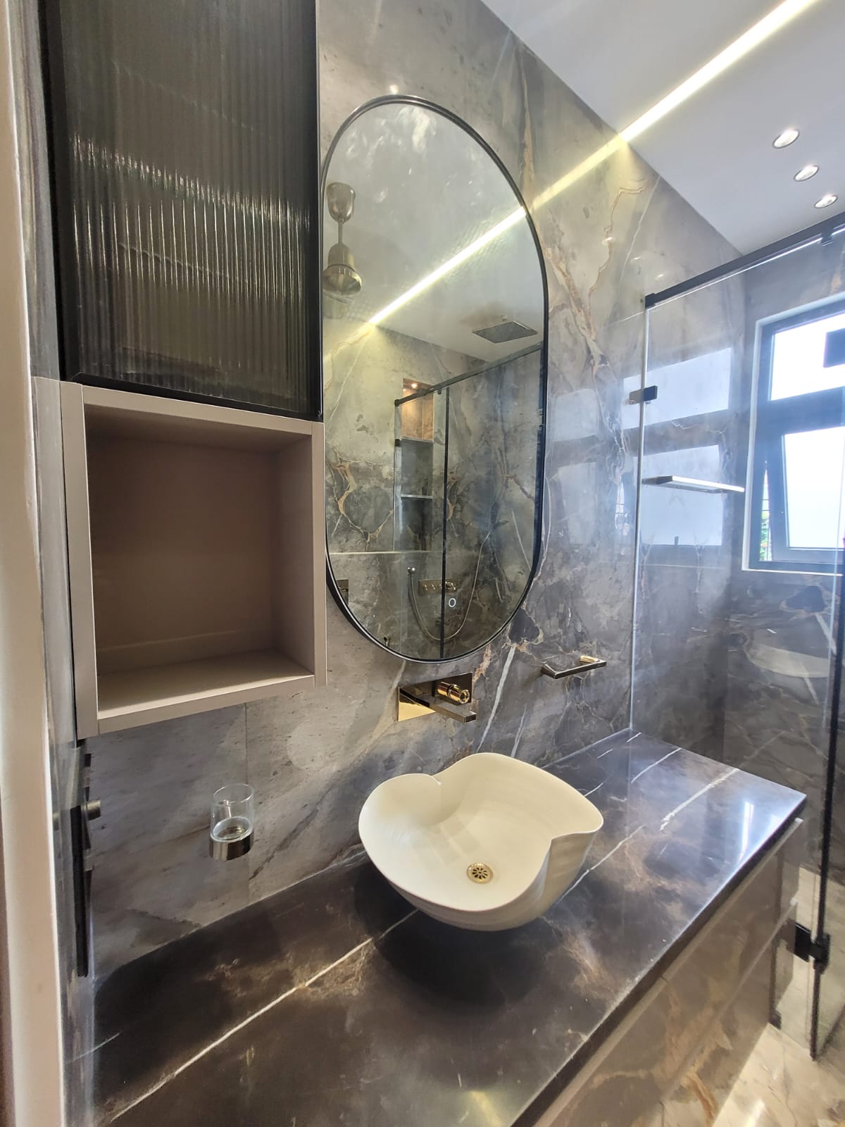 Premium bathroom with grey marble and oval designer mirror, Delhi NCR
